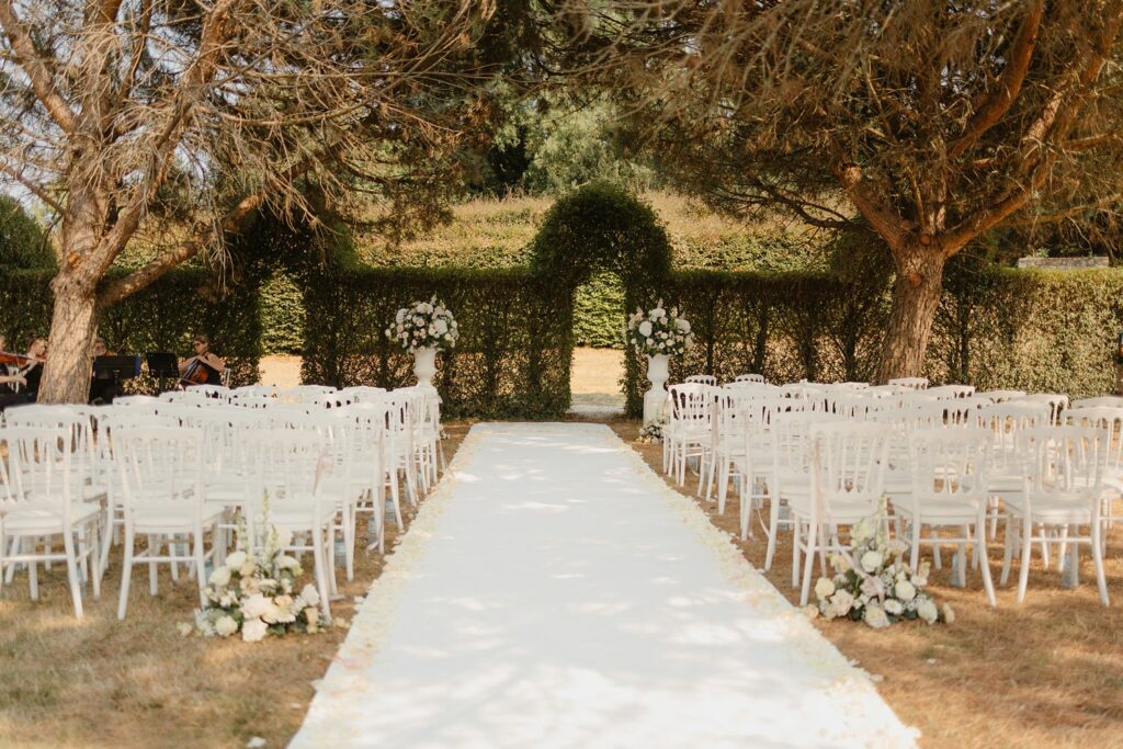 Outdoor ceremony under the trees at Domaine d'Essendieras by Jade Sequeval French Photographer