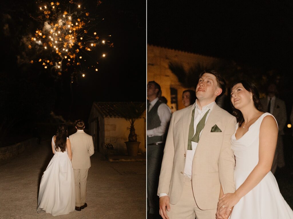 Newlyweds admiring fireworks during their wedding at Château de Garde by French wedding photographer Jade